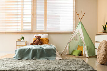 Childhood development and play, cozy bedroom interior with teepee tent and bed for kids in a modern home with natural light and minimalist decor © Pixel-Shot