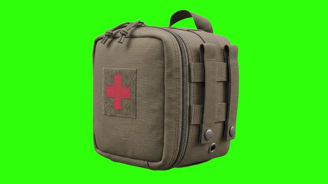 Tactical military IFAK medical pouch with red cross patch and MOLLE webbing isolated on a studio chroma key green background. Perfect for combat medic promos, tactical training videos, survival gear a