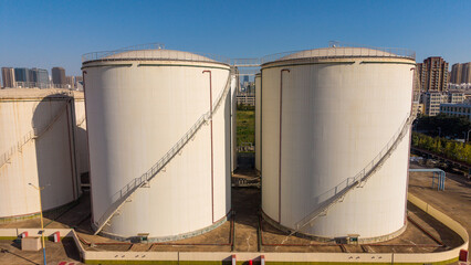 Large white grain storage silos in an urban industrial area © Zhaorui