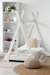 Modern nursery interior design, minimalist kids bedroom with teepee bed frame and white bookshelf for child development and cozy home environment © Pixel-Shot