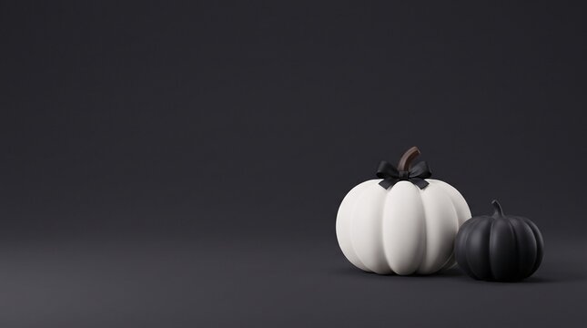 elegant monochrome halloween pumpkin arrangement featuring a white ribbed gourd with a black satin bow beside a smaller charcoal pumpkin on a dark minimalist background with generous copy space