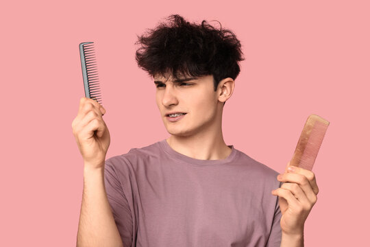 Hair care and grooming routine, young man choosing between different hair combs for styling messy hair on a solid pink background