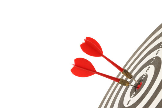 Red darts puncture bullseye on target board, isolated on white, PNG