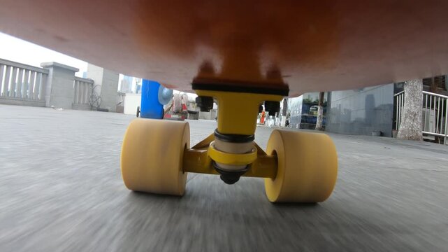 Skateboarder riding skateboard on street in chongqing city ,China.Under skateboard  POV