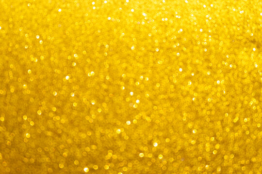 Defocus bright gold glitter bokeh texture background. Concept for abstract luxury celebration, sparkling festive holiday backdrop, elegant Christmas or New Year design template with empty copy space.