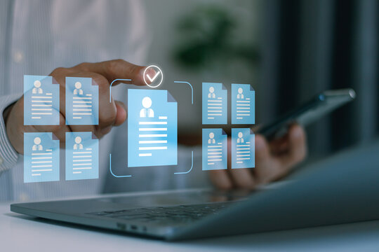 Human resources management concept showing a professional selecting a qualified candidate profile from multiple employee records using digital recruitment technology on a laptop.