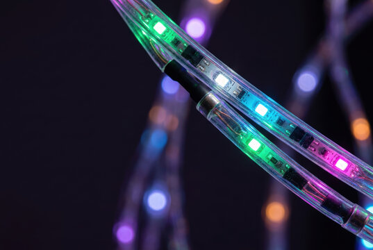 Led strip colorful neon glowing technology flexible cable light abstract background electric illumination decoration modern detail closeup multicolor dark pattern design equipment wire circuit