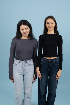 Two Young Multiethnic Women Standing Side by Side in Denim