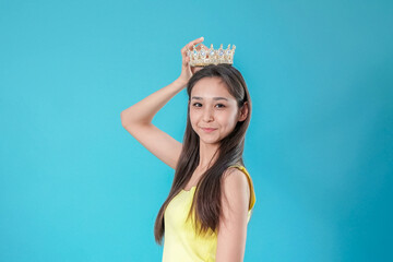 Graceful Young Woman Holding a Gold Crown on Her Head © Midea