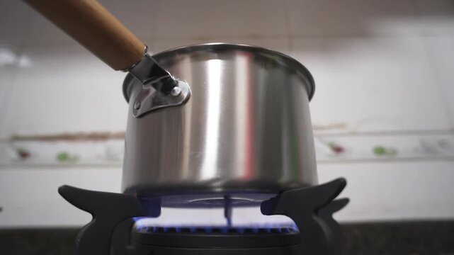 Stainless steel saucepan on gas stove, kitchen, Shanghai, China