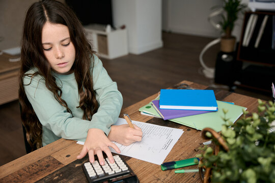 Young girl studying math doing homework
