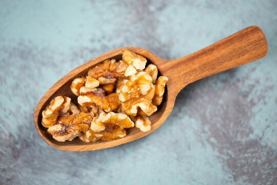 Walnuts in a wooden shovel, healthy nuts food, nutrition, ingredients for baking, protein and antioxidants