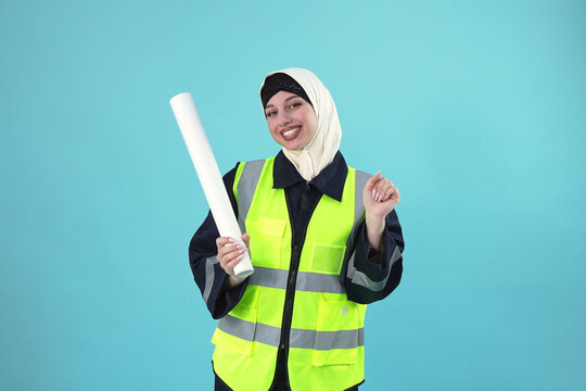 Smiling Muslim Female Engineer In Safety Vest With Paper Roll