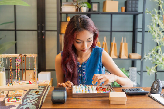 Asian business owner qc all handcrafted jelvery in store