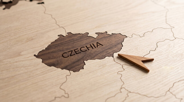 Wooden pointer indicating Czechia on a handcrafted wooden map representing European travel