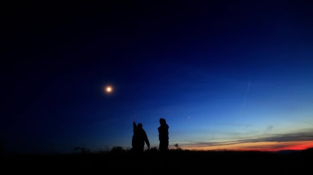 Amateur astronomers enjoying night sky with stars, planets, Moon eclipse and other celestial objects.