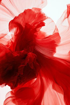 Red fabric gracefully flowing and creating dynamic abstract patterns. Capturing concepts of motion, energy, and softness