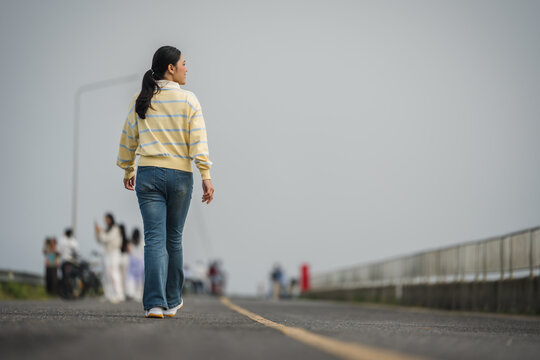 woman walking on a road on mountain in morning
