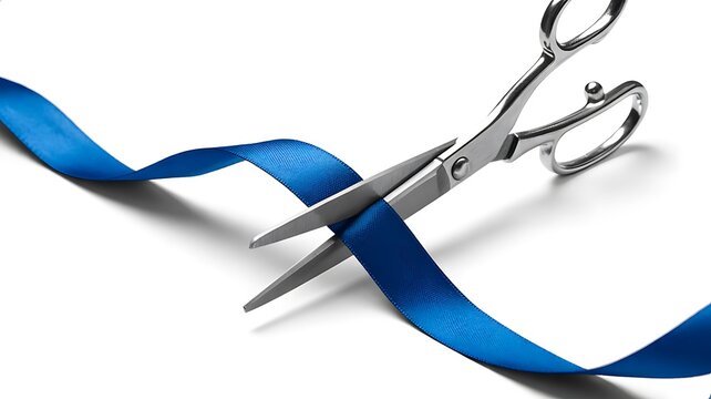 Silver scissors cutting a blue ribbon isolated on a white background