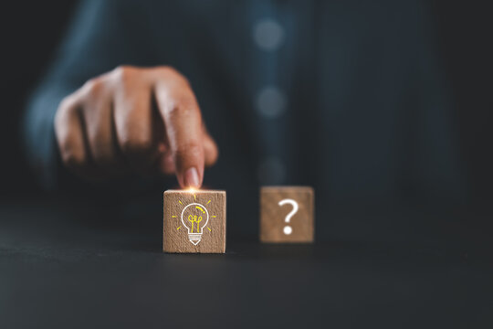 From Questions to Ideas. Wooden blocks with question marks and a lightbulb icon. Quick tips, problem solving, idea discovery, creativity and turning uncertainty into innovation.