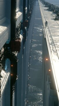 Futuristic Cityscape with Towering Structures and Waterway Below, a Solitary Figure Walks on a High Ledge