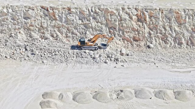Panoramic Drone Flyover of Limestone Quarry with Excavator and Large Rock Excavation Site