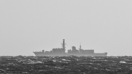  STORMY SEA AND GUIDED MISSILE FRIGATE - Outline of a warship on the horizon (photo with "sandstone" texture applied)  © Wojciech Wrzesień
