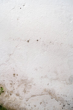 Close-up of a textured white wall showcasing subtle stains and imperfections.