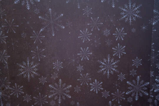 Delicate snowflakes adorned against a dark background create a winter wonderland effect.
