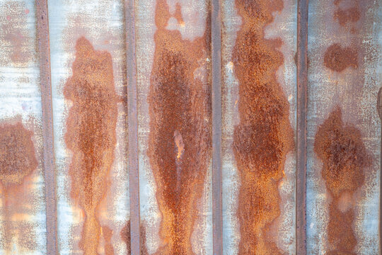 Close-up of weathered rusty metal with distinct patterns and textures.