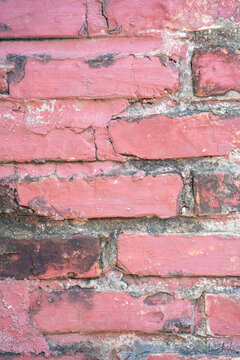 Textured pink brick wall with weathered spots and subtle imperfections.