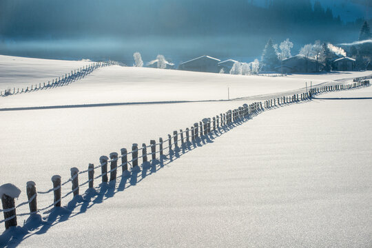 Winter landscape with snow fence and farmhouses in Flachau Austria