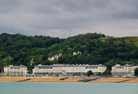 Dover beach with white buildings and green hills in summer