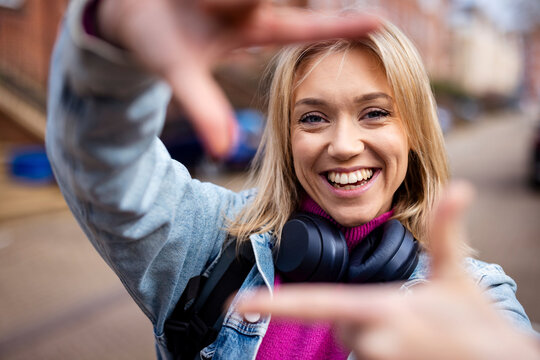 Woman frames a portrait with her hands in Southampton city