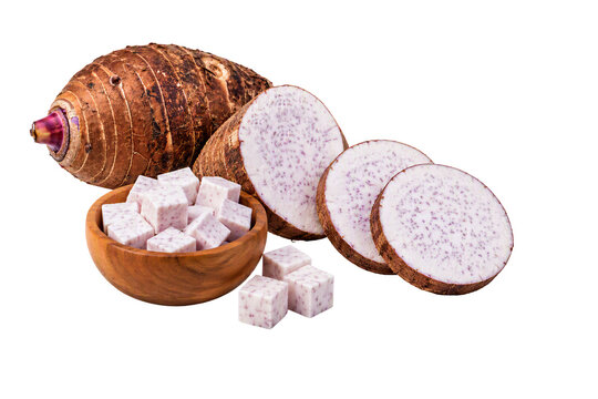 Taro root whole, sliced rounds, and cubed pieces in a wooden bowl isolated on white transparent background, PNG