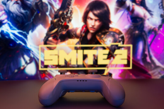 Atlanta, United States - 15 Oct 2026: A game controller in front of a Smite 2 Game screen.