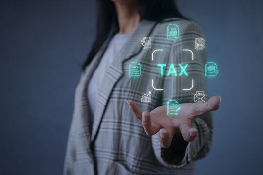 Female in Suit Showing Holographic Tax Document Icons Against Grey Background
