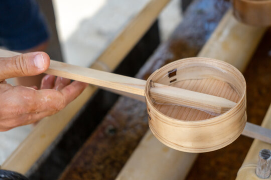 Hand with hishaku at chozuya in Shitenno-ji Temple, Osaka