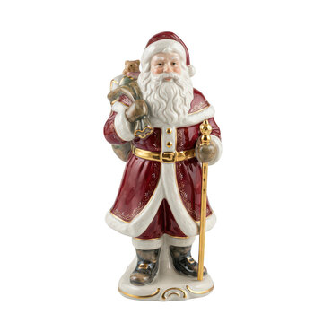 Ceramic santa claus figurine holding a sack and staff isolated on transparent background