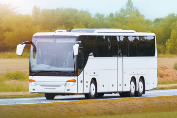 White holiday bus under soft summer sky © AlexGo