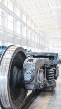 Heavy industrial flywheel and mechanical drive assembly inside a bright factory. Engineering equipment, manufacturing infrastructure, and industrial production concept with copy space.