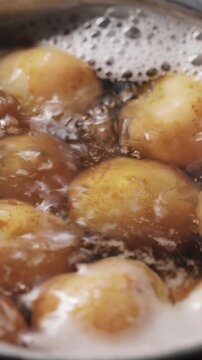 Potatoes Boiling in Saucepan Bubbling Water Vertical Video