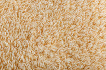 Soft, beige, plush fabric texture close-up © schankz