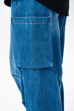 Close-up of loose-fit blue jeans; a shot focusing on fashion apparel details.