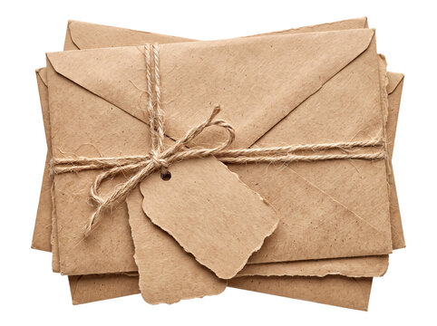 Vintage kraft paper envelopes stack tied with jute twine string and blank gift tags isolated on black background for postal mail, rustic wedding invitation, nostalgic love letters, and eco packaging.