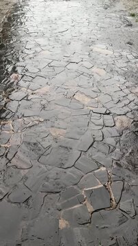 Shallow Water Ripples Across a Cracked Stone Path