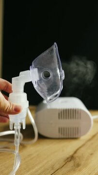 Compressor nebulizer operating and producing a fine mist, demonstrating the function of an inhalation therapy device.

