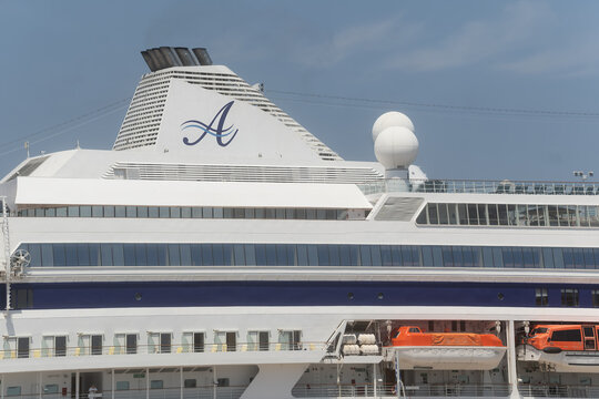 Rhodes - Greece June 01, 2026: Funnel bearing a stylized letter A logo atop the upper decks and radar domes of an Astoria Grande cruise ship in Rhodes, Greece.
