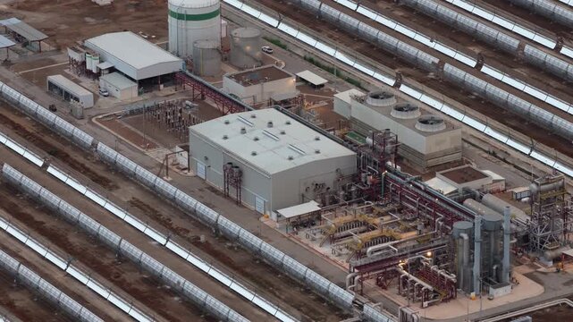 Aerial view of Central Termosolar Helioenergy 1 with parabolic troughs and industrial infrastructure in Ecija, Andalusia, Spain.