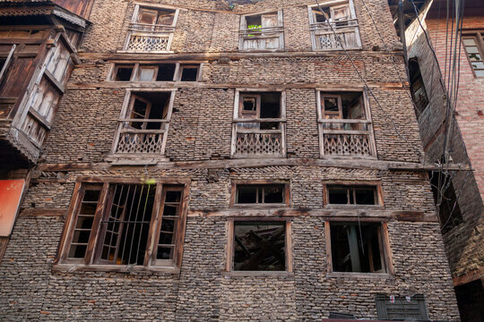 Abandoned multi storey stone house with broken wooden windows, Jammu and Kashmir, Srinagar, India